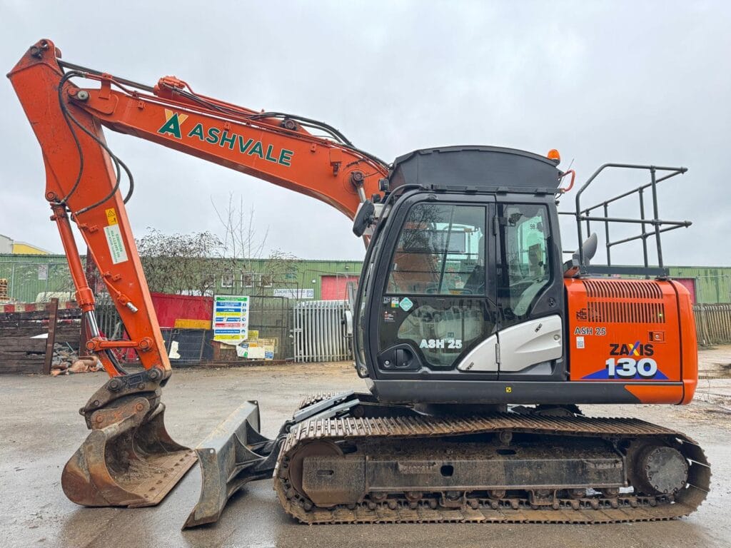Orange excavator parked on construction site