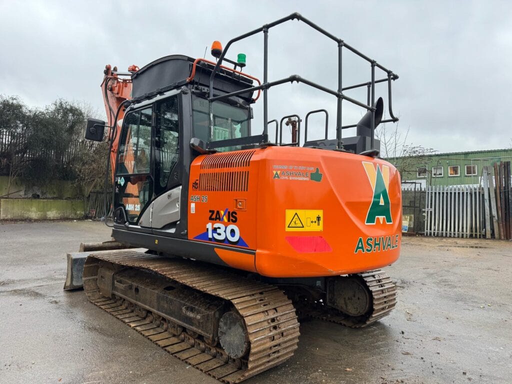 Orange excavator on construction site in Ashvale yard
