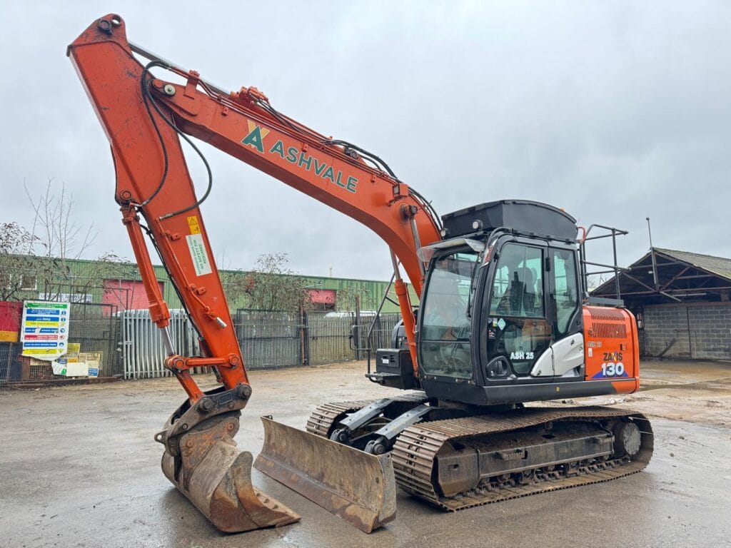 Orange excavator parked on a construction site