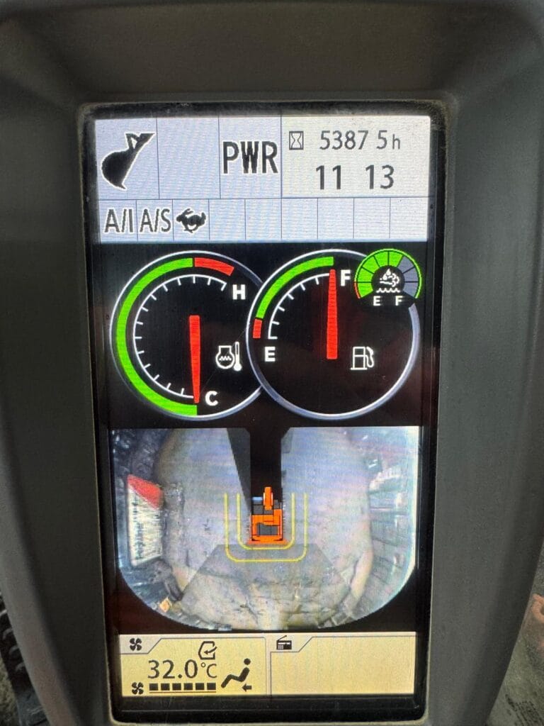 Vehicle dashboard display with gauges and rear camera view