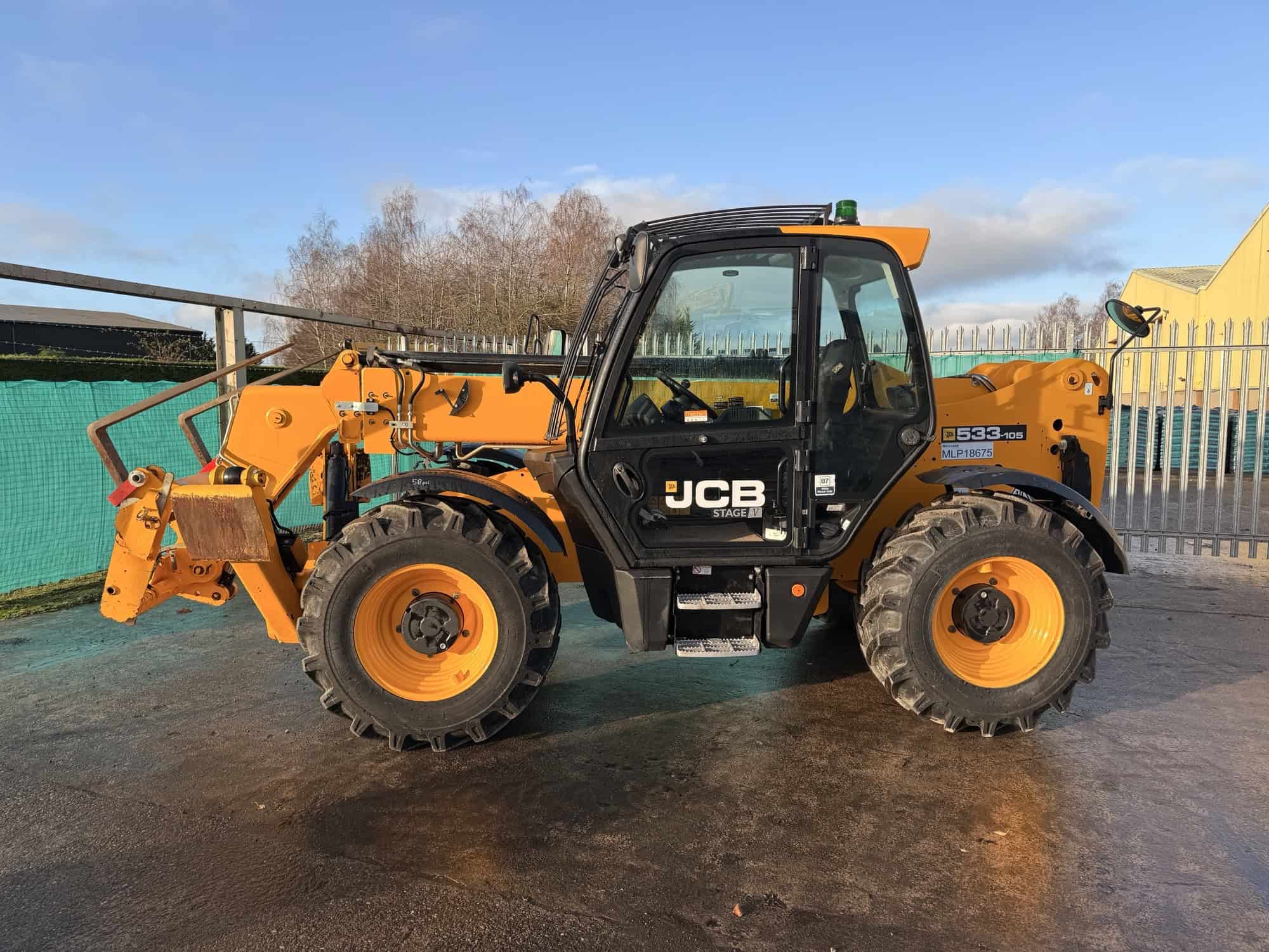 Yellow JCB telescopic handler on construction site