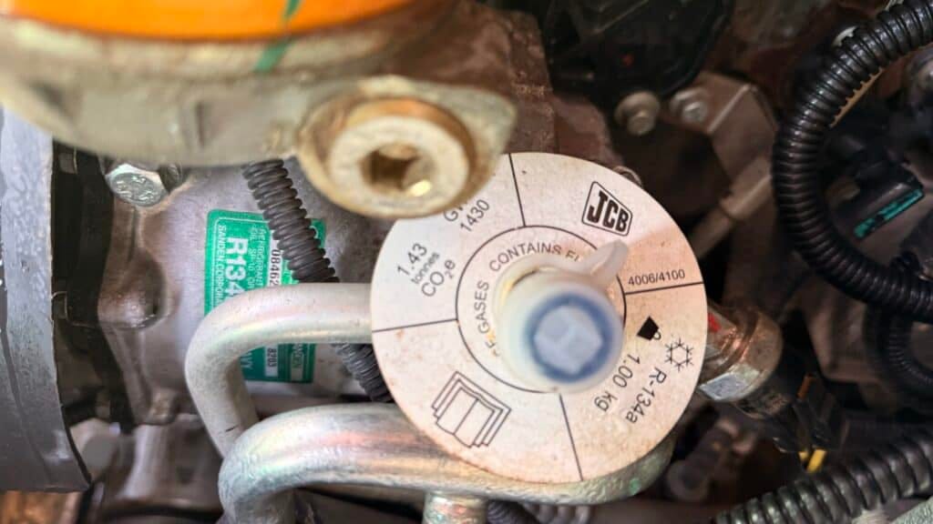 JCB R134a refrigerant label on engine component