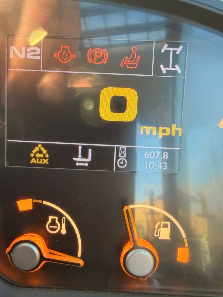Vehicle dashboard showing speed and warning indicators