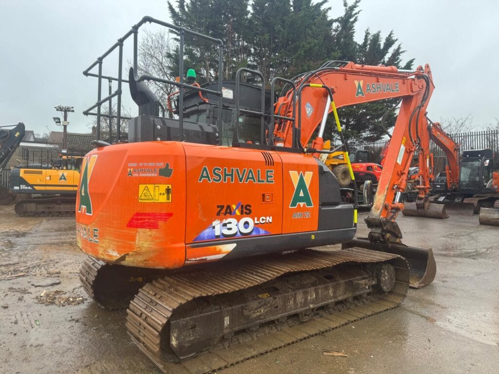 Orange Ashvale excavator parked on muddy construction site
