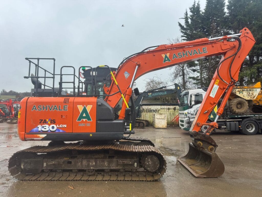 Orange Ashvale excavator parked on wet construction site